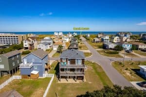 a beach access area with houses and a body of water