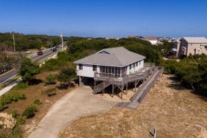 Stilt beach house with large deck near OBX, North Carolina, ocean, and scenic views.