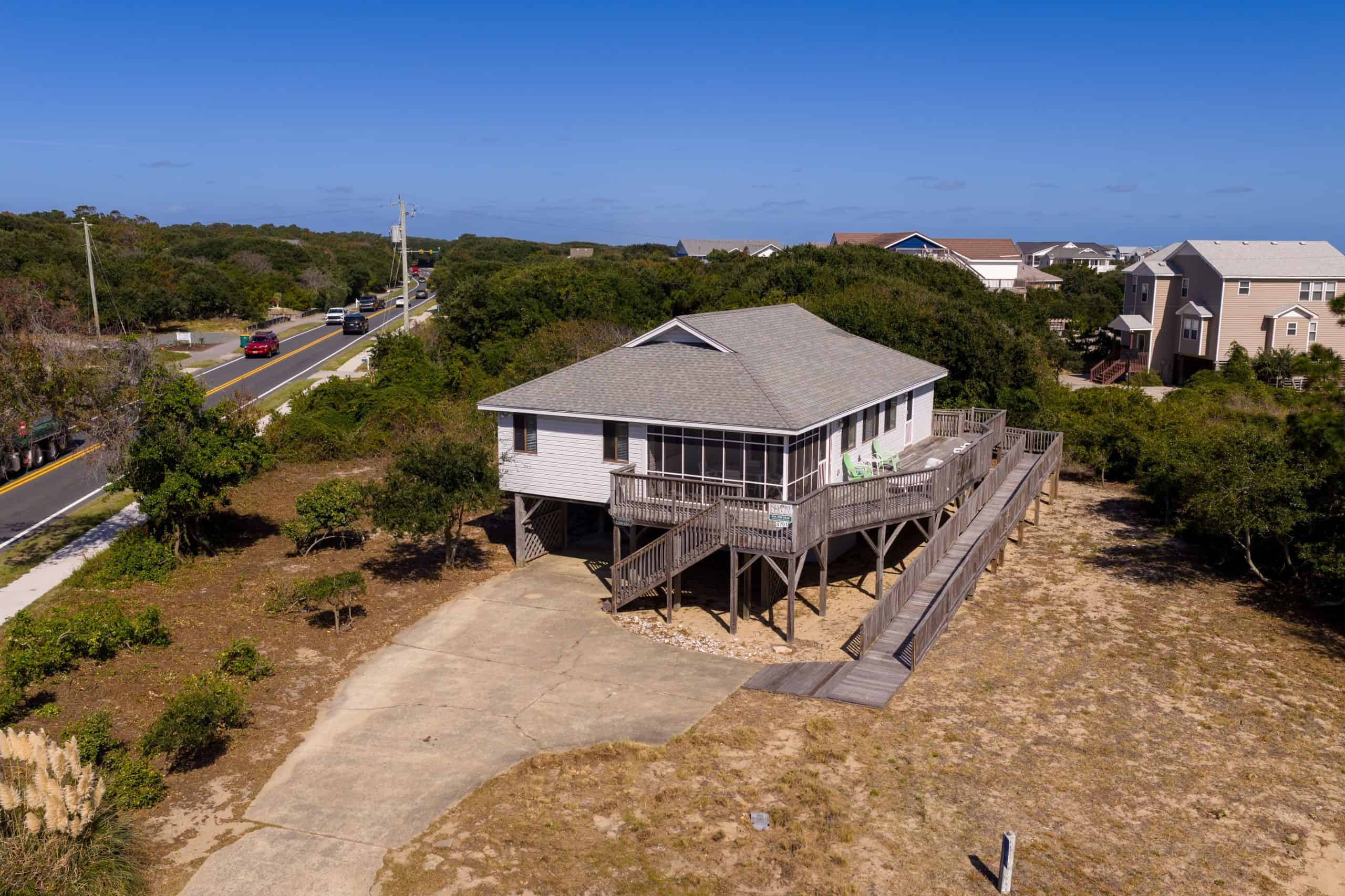 Stilt beach house with large deck near OBX, North Carolina, ocean, and scenic views.