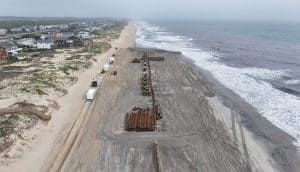 Beach nourishment project along coastline.